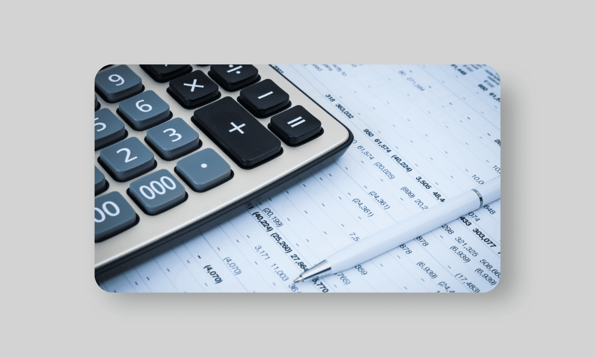 A calculator laying on a business report