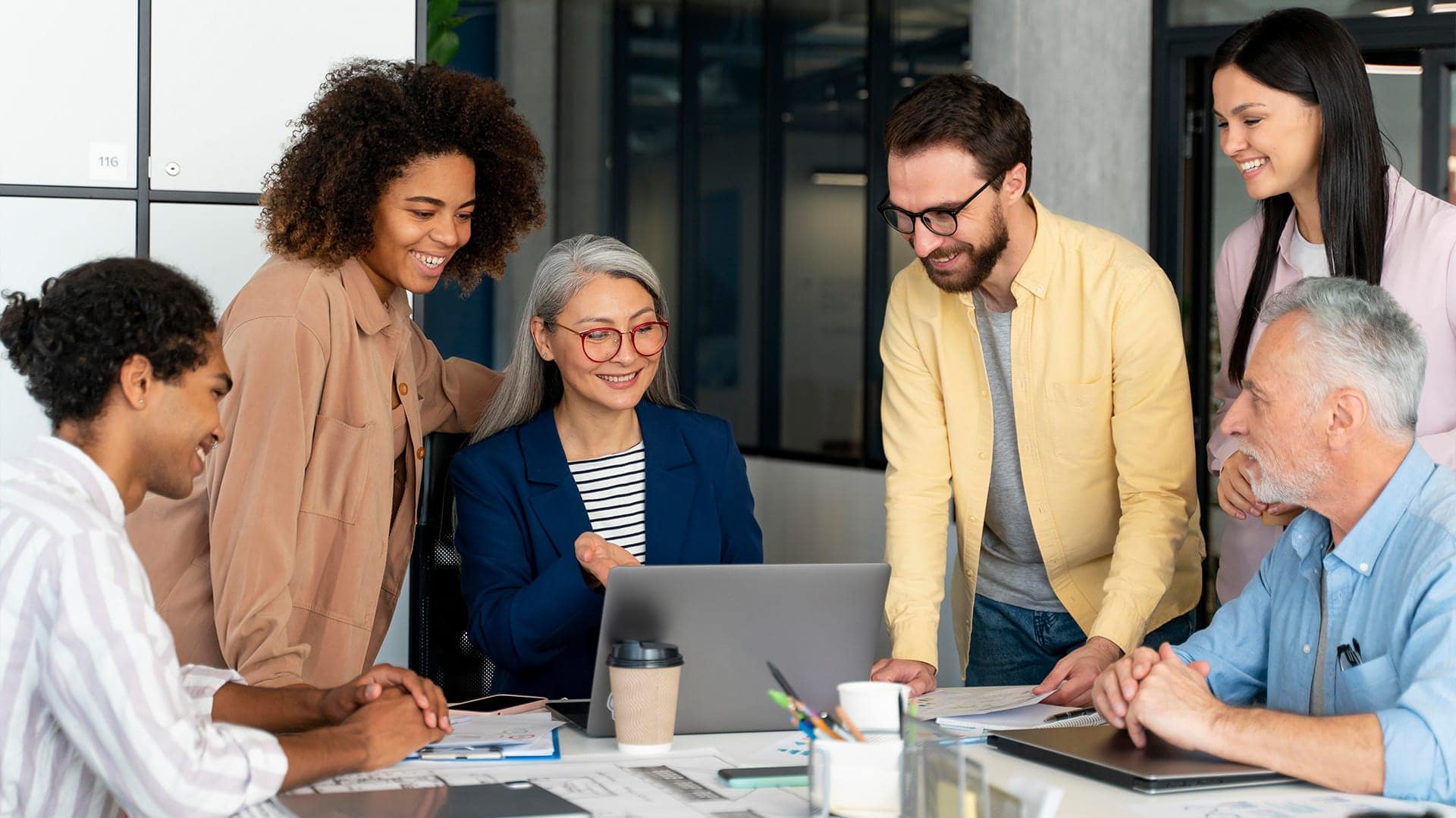 Employees working together around a desk