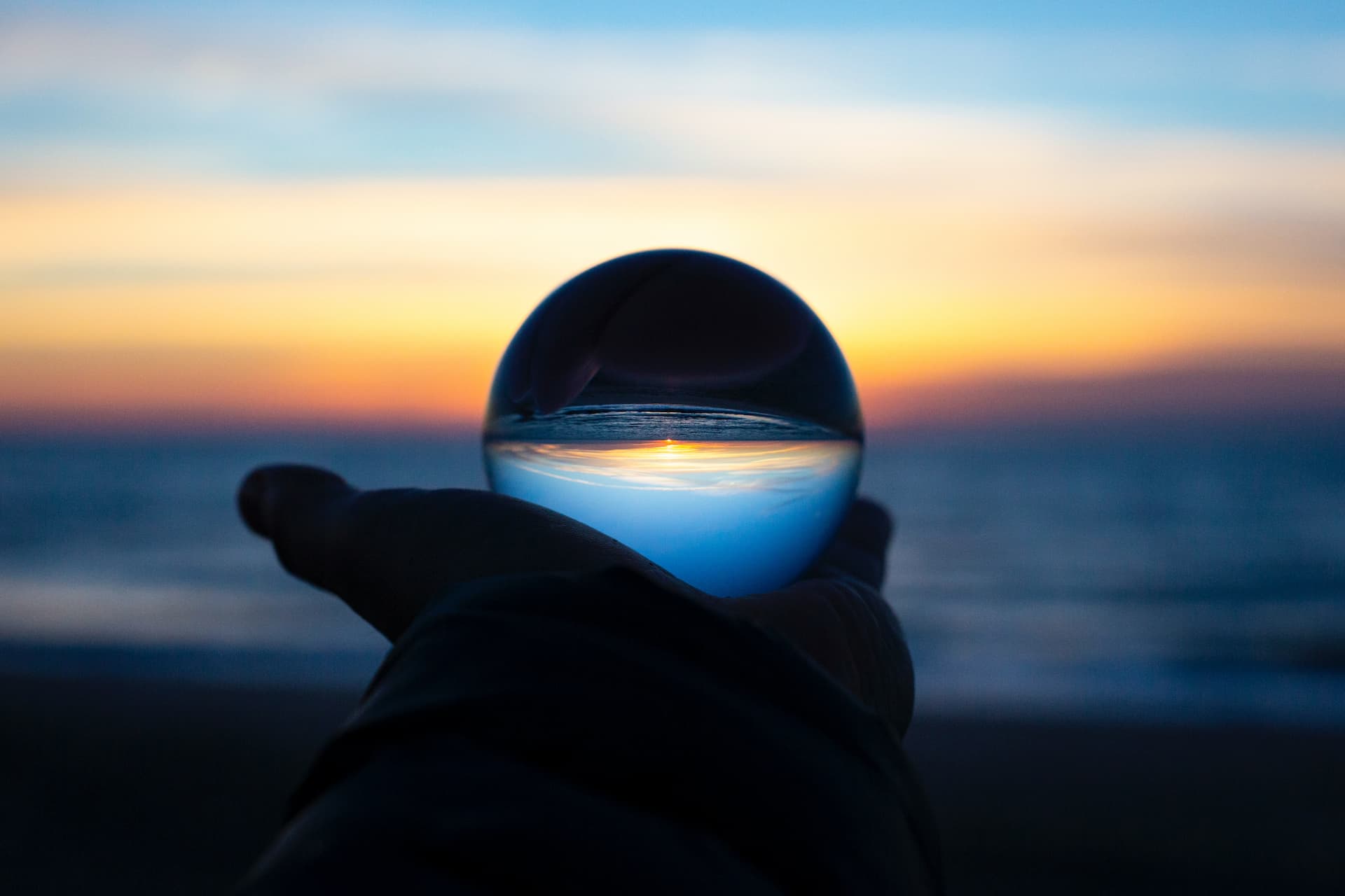 Image of a glass ball in the palm of a hand
